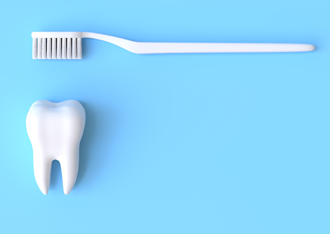 A white toothbrush and a tooth on a blue background