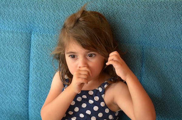 A little girl sucking her thumb