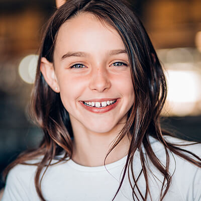 A young girl smiling