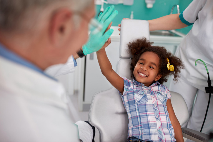 child high fiving a dentist