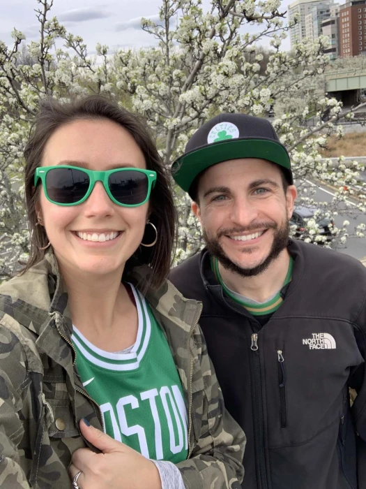 Dr. Alan with his partner Ashley wearing Boston Celtics attire.