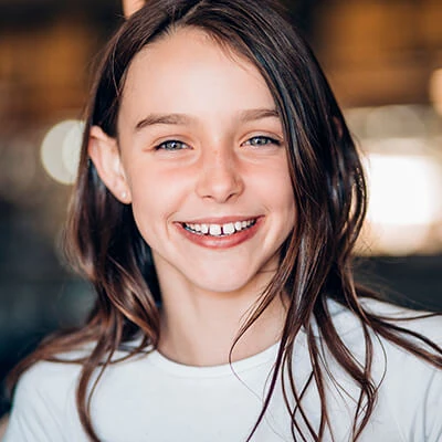 A young girl smiling.